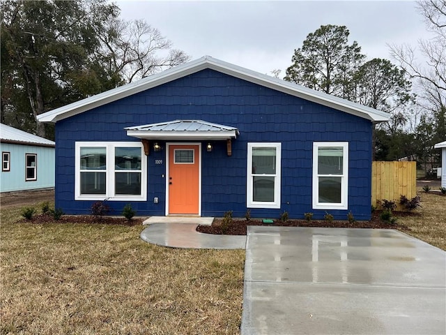 bungalow-style home featuring a front yard