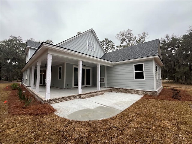 rear view of property featuring a patio area and ceiling fan