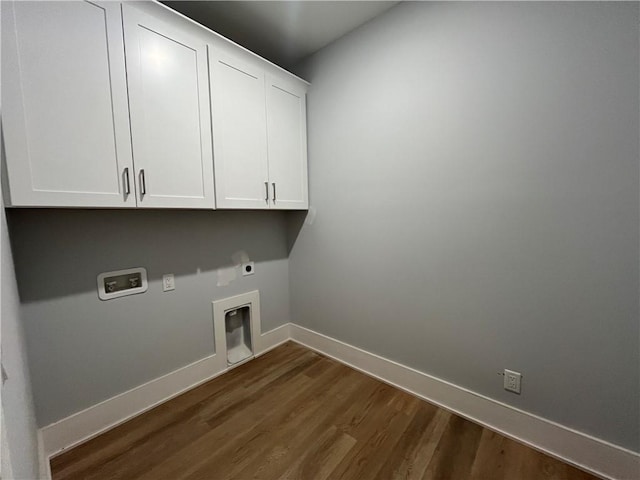 clothes washing area featuring cabinets, hookup for a washing machine, dark wood-type flooring, and hookup for an electric dryer