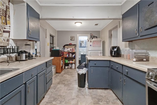 kitchen with white refrigerator, ornamental molding, stainless steel electric range oven, and blue cabinetry