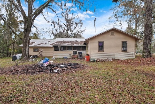 back of property with a sunroom and cooling unit