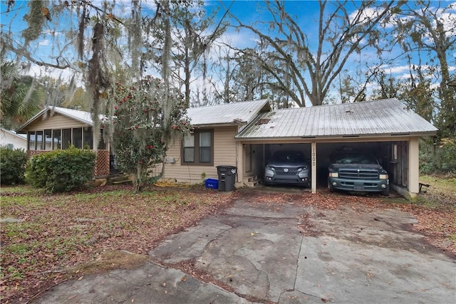 view of front of property featuring a garage and a sunroom