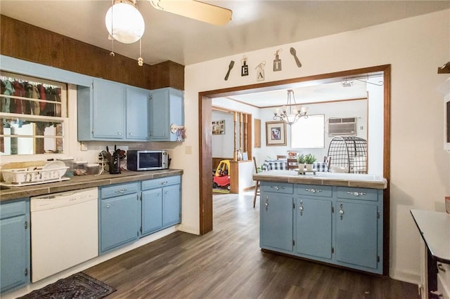 1405 Grove Ave, Waycross, GA 31501 - kitchen with dishwasher, blue cabinetry, stainless steel microwave, a chandelier, and dark wood finished floors