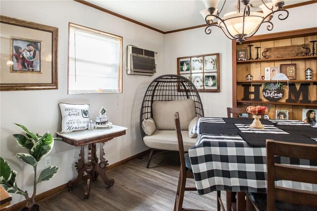 1405 Grove Ave, Waycross, GA 31501 - dining room featuring a chandelier, an AC wall unit, wood finished floors, crown molding, and baseboards
