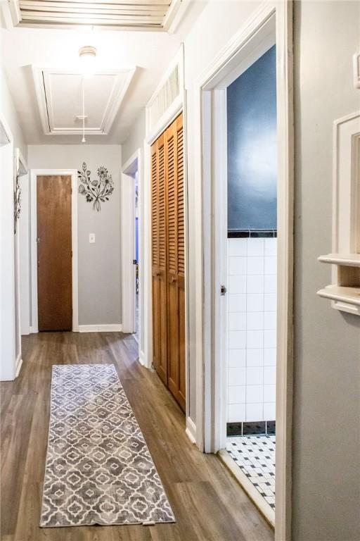 1405 Grove Ave, Waycross, GA 31501 - hallway with attic access, wood finished floors, and baseboards