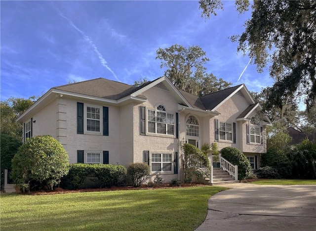 412 Palm Dr, Saint Simons Island, GA 31522 - view of front of property with stucco siding and a front yard