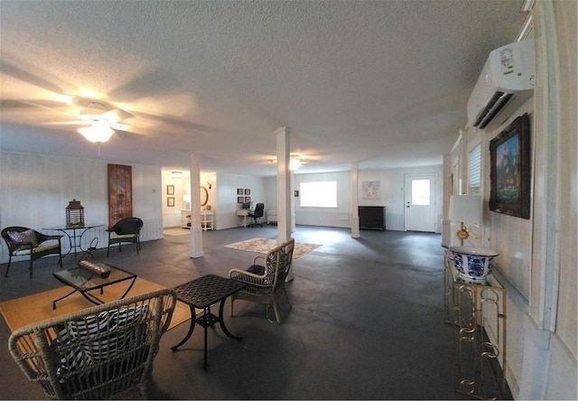 412 Palm Dr, Saint Simons Island, GA 31522 - dining area with an AC wall unit, a textured ceiling, a ceiling fan, and concrete flooring