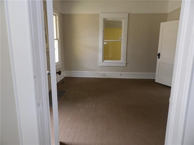 unfurnished room featuring dark hardwood / wood-style flooring