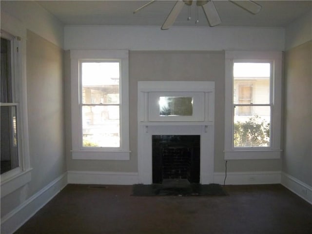 unfurnished living room with ceiling fan