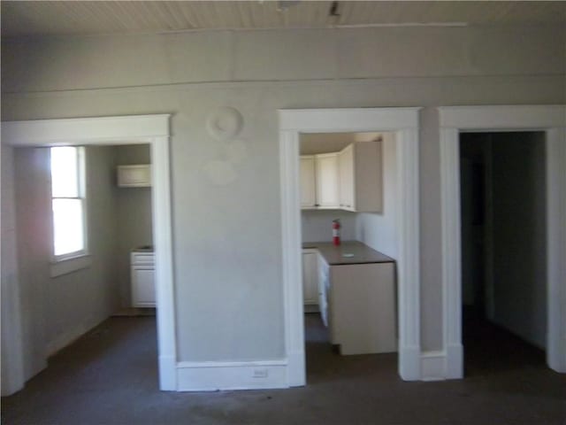 unfurnished bedroom featuring dark colored carpet