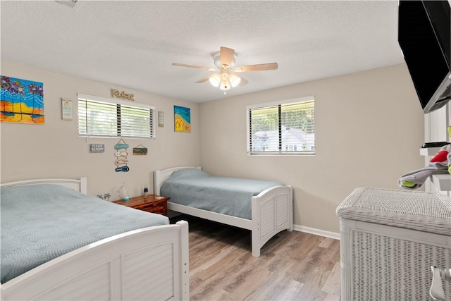 127 Landover Dr, Brunswick, GA 31525 - bedroom with light wood-type flooring, a textured ceiling, baseboards, and ceiling fan