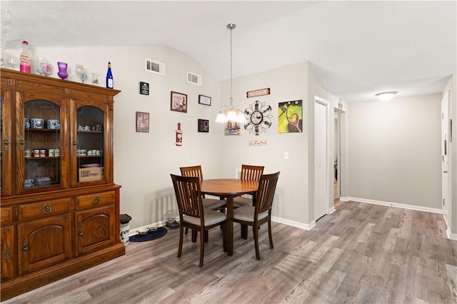 127 Landover Dr, Brunswick, GA 31525 - dining space with a chandelier, lofted ceiling, light wood-type flooring, and baseboards