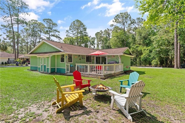 127 Landover Dr, Brunswick, GA 31525 - back of house featuring a fire pit, a wooden deck, and a yard