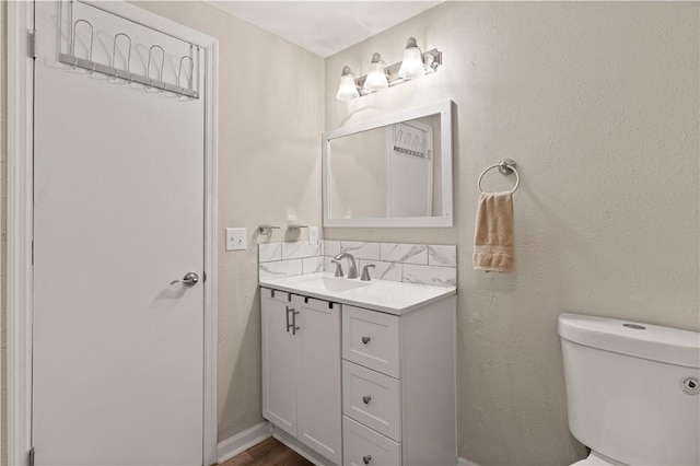 127 Landover Dr, Brunswick, GA 31525 - bathroom with vanity, toilet, and backsplash