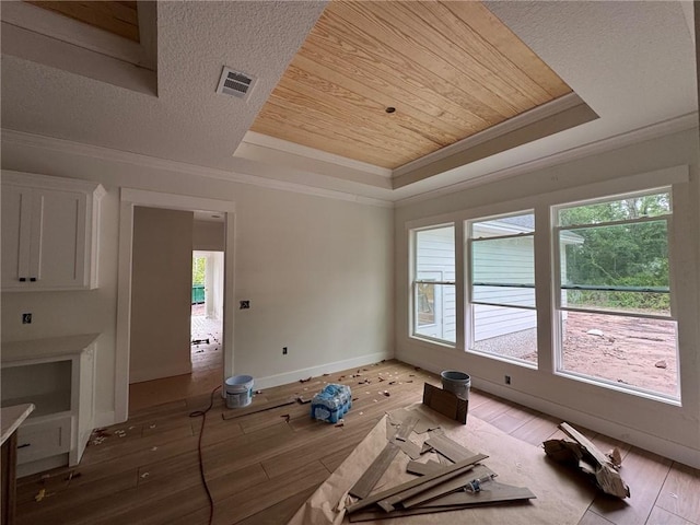 701 Broadwood Dr, Woodbine, GA 31569 - interior space with a tray ceiling, wooden ceiling, crown molding, and light wood-style floors