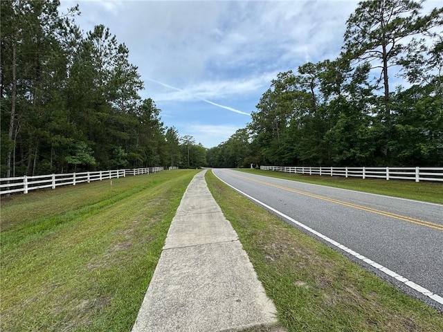 701 Broadwood Dr, Woodbine, GA 31569 - view of asphalt road with a view of trees