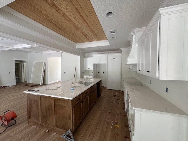 701 Broadwood Dr, Woodbine, GA 31569 - kitchen with dark wood-style floors, white cabinets, a spacious island, and open floor plan
