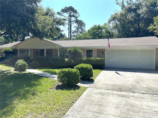 single story home with a front yard and a garage