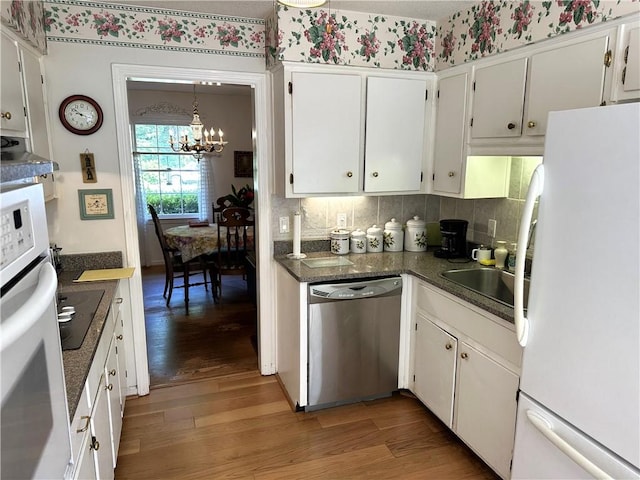 kitchen with white appliances, a chandelier, dark hardwood / wood-style floors, white cabinetry, and hanging light fixtures