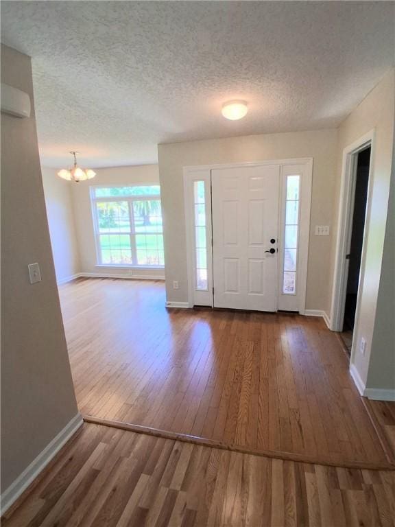 43 Shadowlake Ct, Brunswick, GA 31525 - foyer featuring wood finished floors, a chandelier, and a textured ceiling