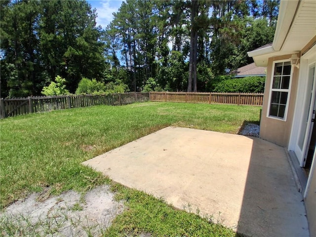 43 Shadowlake Ct, Brunswick, GA 31525 - fenced backyard with a patio and view of wooded area