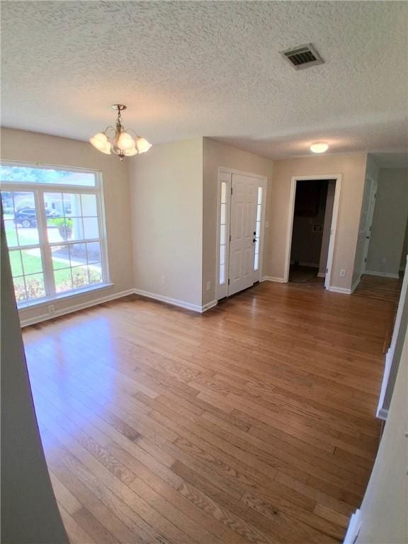 43 Shadowlake Ct, Brunswick, GA 31525 - entryway with a chandelier, a textured ceiling, and wood finished floors
