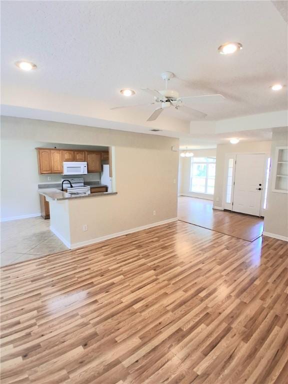 43 Shadowlake Ct, Brunswick, GA 31525 - unfurnished living room with light wood-style flooring, ceiling fan, recessed lighting, and a chandelier