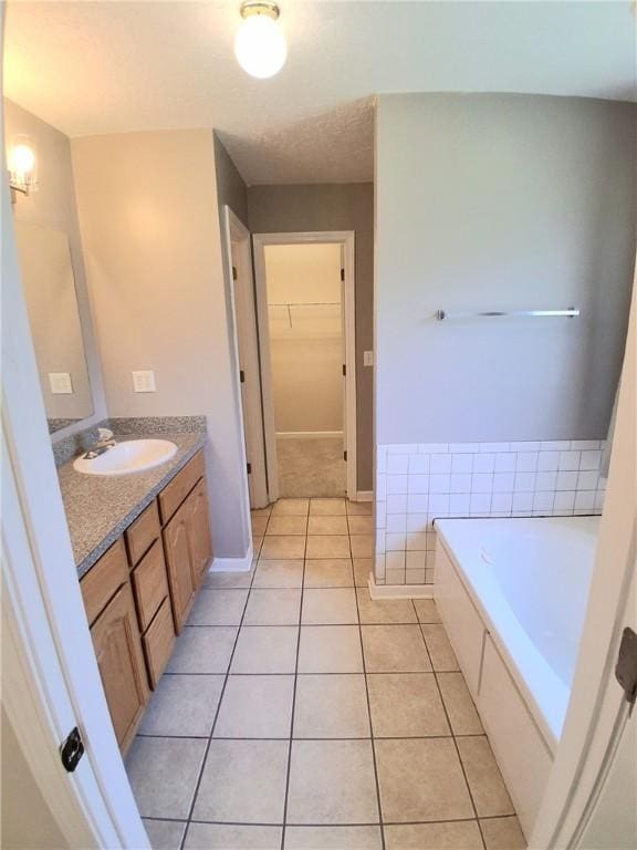 43 Shadowlake Ct, Brunswick, GA 31525 - bathroom featuring vanity, tile patterned floors, a bath, and a walk in closet