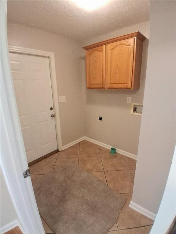43 Shadowlake Ct, Brunswick, GA 31525 - washroom featuring cabinet space, light tile patterned flooring, hookup for a washing machine, and a textured ceiling