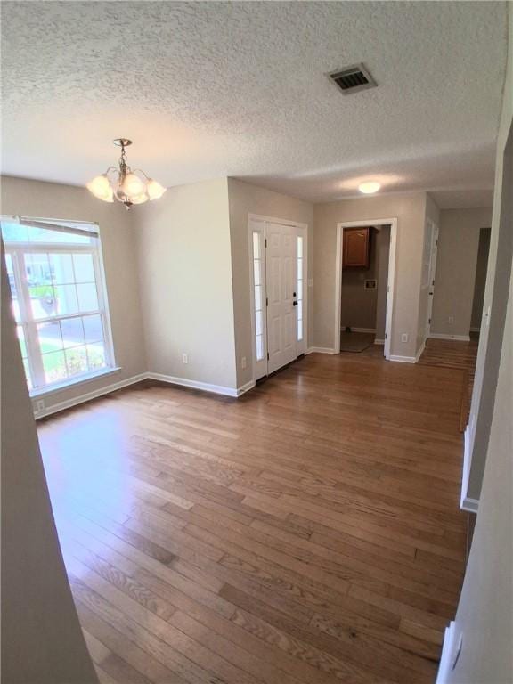 43 Shadowlake Ct, Brunswick, GA 31525 - entryway featuring wood finished floors, a textured ceiling, and a chandelier