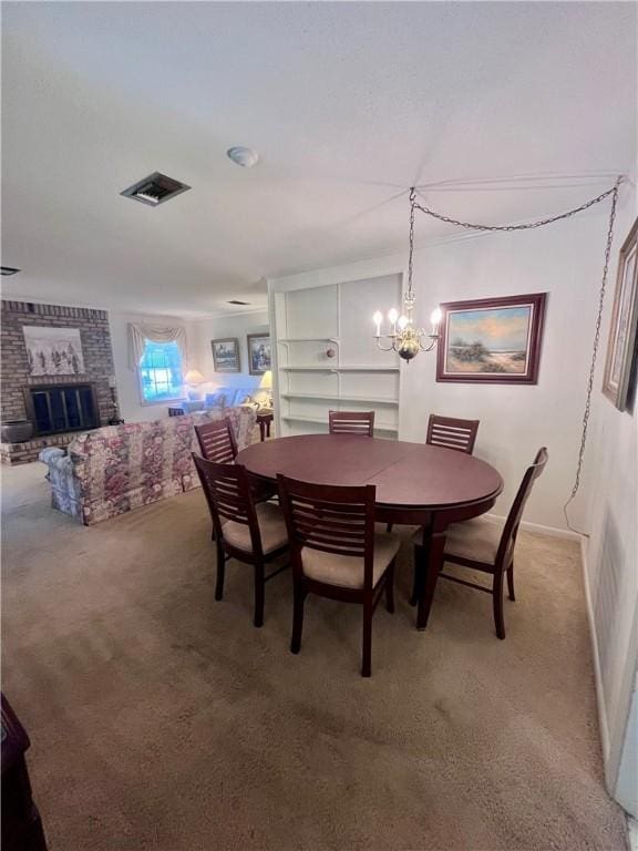 119 Saint Clair Dr, Saint Simons Island, GA 31522 - dining space featuring light colored carpet, a fireplace, and a chandelier