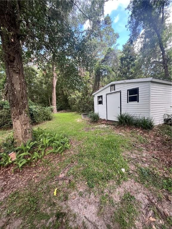 119 Saint Clair Dr, Saint Simons Island, GA 31522 - view of green lawn with a storage shed