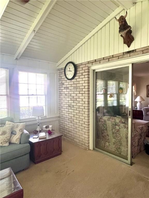 119 Saint Clair Dr, Saint Simons Island, GA 31522 - carpeted living room featuring wooden ceiling and brick wall