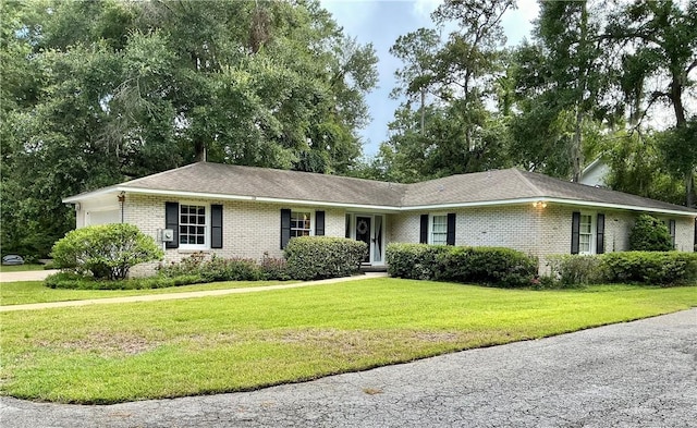 119 Saint Clair Dr, Saint Simons Island, GA 31522 - single story home featuring brick siding, a garage, and a front lawn
