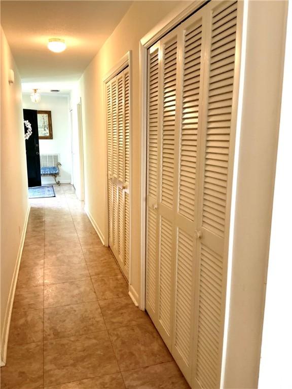 119 Saint Clair Dr, Saint Simons Island, GA 31522 - hallway featuring light tile patterned floors