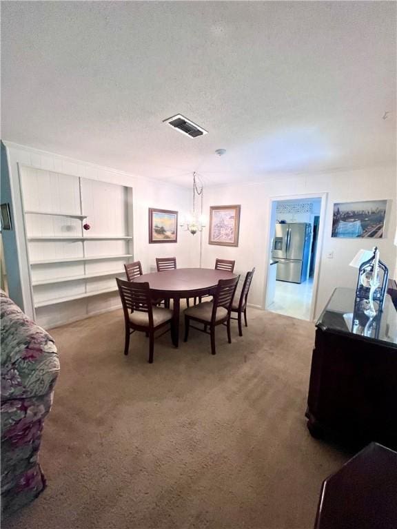 119 Saint Clair Dr, Saint Simons Island, GA 31522 - carpeted dining space featuring a textured ceiling