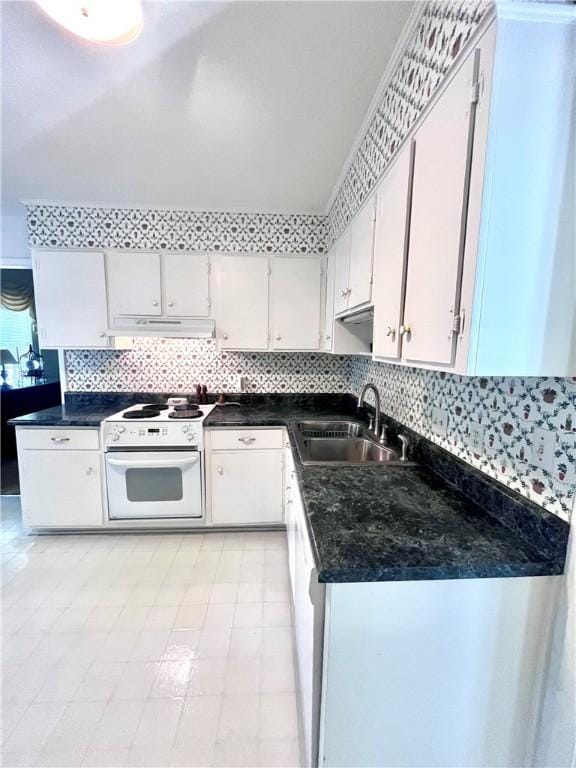 119 Saint Clair Dr, Saint Simons Island, GA 31522 - kitchen featuring under cabinet range hood, dark countertops, white cabinets, and oven