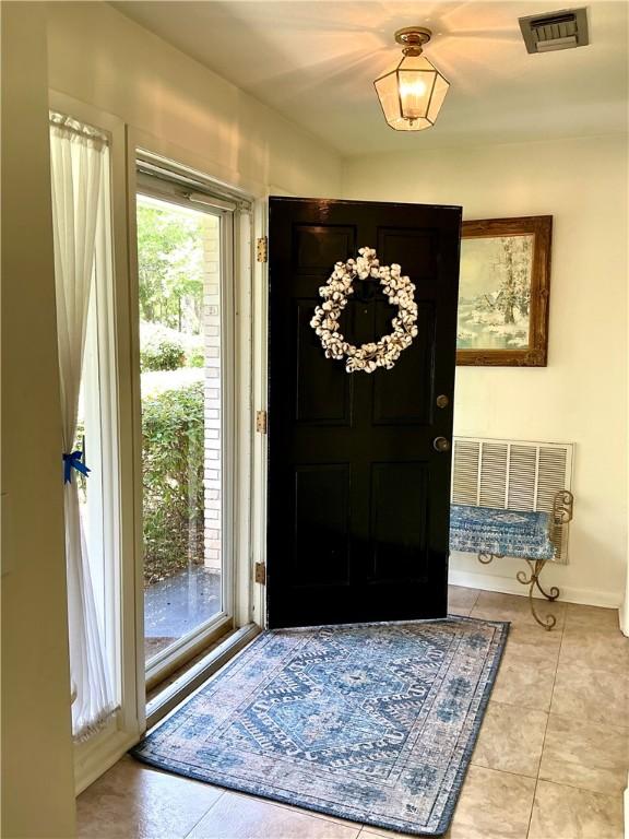 119 Saint Clair Dr, Saint Simons Island, GA 31522 - entrance foyer featuring light tile patterned floors and baseboards