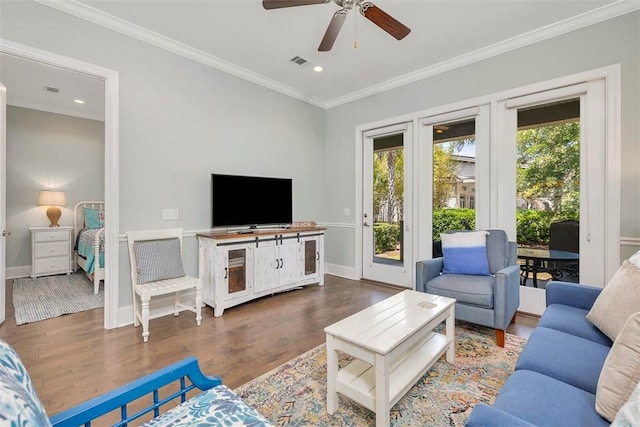 living room with visible vents, ornamental molding, and dark wood-type flooring