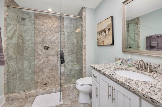 full bath featuring vanity, toilet, and a stall shower