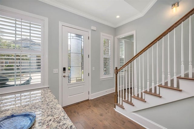 foyer featuring crown molding, stairs, and a wealth of natural light
