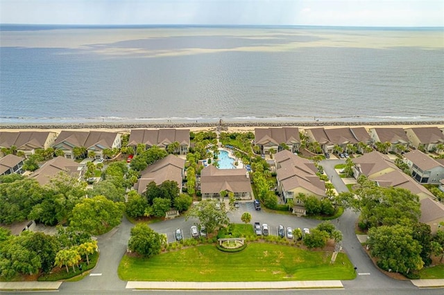 birds eye view of property featuring a water view, a residential view, and a beach view