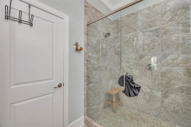 full bathroom featuring crown molding, baseboards, and a shower stall
