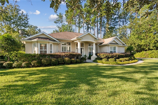 single story home featuring a front lawn