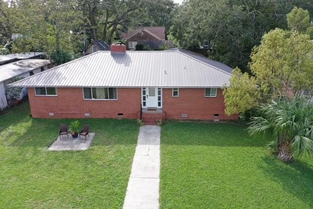 exterior space featuring a lawn and a patio area