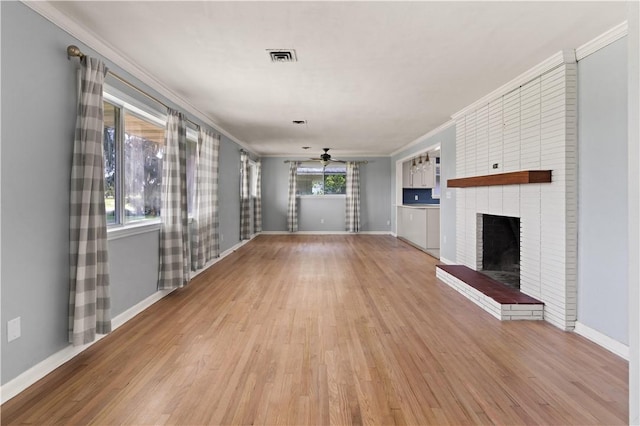 1207 Lanier Blvd, Brunswick, GA 31520 - unfurnished living room with a fireplace, light hardwood / wood-style flooring, ceiling fan, and crown molding
