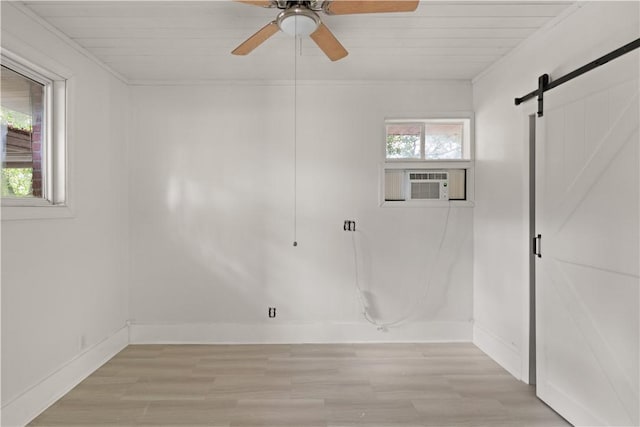 1207 Lanier Blvd, Brunswick, GA 31520 - empty room with cooling unit, ceiling fan, a barn door, light hardwood / wood-style floors, and wood ceiling