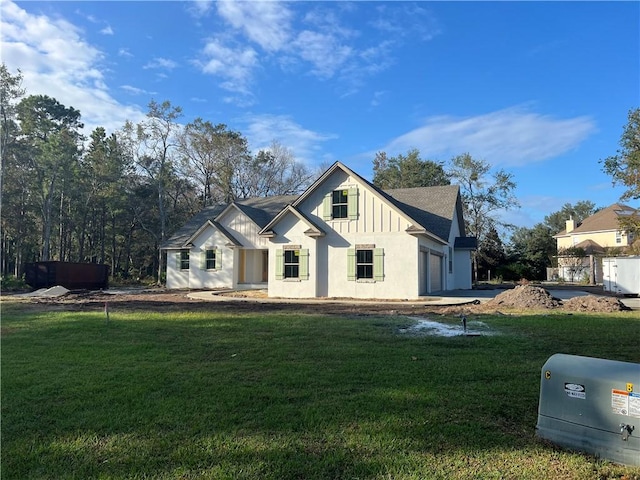 modern farmhouse style home with a garage and a front lawn