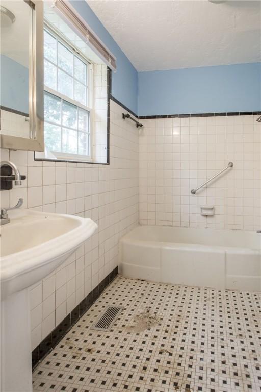 1701 Satilla Blvd, Waycross, GA 31501 - bathroom with tile walls and a tub to relax in