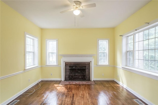 1701 Satilla Blvd, Waycross, GA 31501 - unfurnished living room featuring wood finished floors, baseboards, and a fireplace